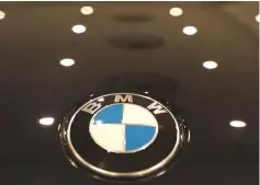  ??  ?? The BMW logo is seen on a vehicle at the New York Auto Show in the Manhattan borough of New York City, New York, US. German carmaker BMW said it will raise the prices of two US-made crossover sport-utility vehicles in China to cope with the additional...