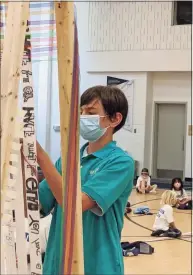  ??  ?? Students at Whitby School in Greenwich work on a social distance-inspired weaving project.