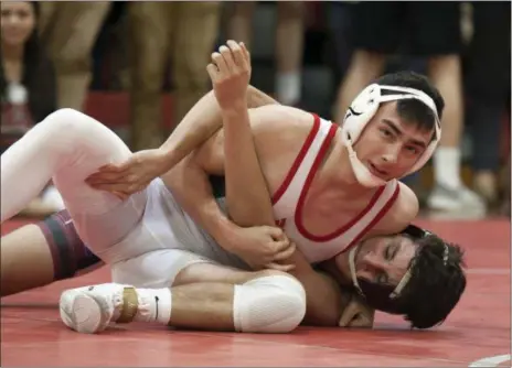  ?? JEN FORBUS — FOR THE MORNING JOURNAL ?? Parker Watson of Lutheran West wrestles Rocky River’s Obaida Abazied during the 145-pound matchup on Dec. 10.