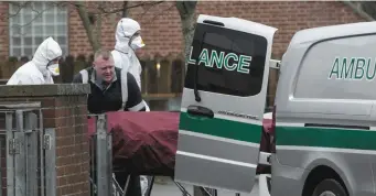  ??  ?? The body of Brian Cassidy is removed from Buirg Na Rí Walk in Balgaddy