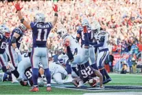  ?? DAVID BUTLER II/USA TODAY SPORTS ?? Patriots wide receiver Julian Edelman (11) celebrates as running back Sony Michel (26) dives for a TD on Sunday.