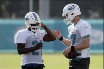  ?? THE ASSOCIATED PRESS ?? Running back Frank Gore, left, is listed as sharing the No. 1 running back spot with incumbent Kenyan Drake on the first depth chart of training camp for the Miami Dolphins.