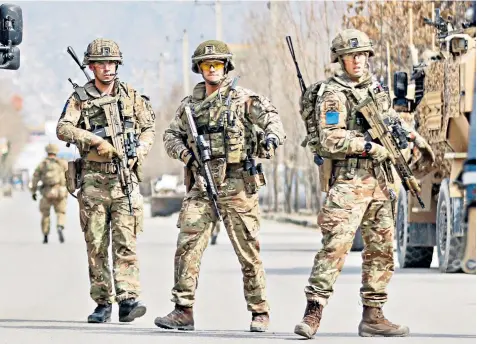  ??  ?? British soldiers guard the site where gunmen linked to Isil attacked a political rally in Kabul, in which at least 32 people were killed and 81 injured