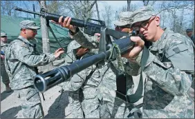  ?? MIKE RANSDELL/KANSAS CITY STAR FILE PHOTOGRAPH ?? Pvt. Brian Hull, right, of Echo Company and others go through a drill in April 2010 on the right formation and areas of coverage for clearing a room at Fort Leonard Wood in Missouri.