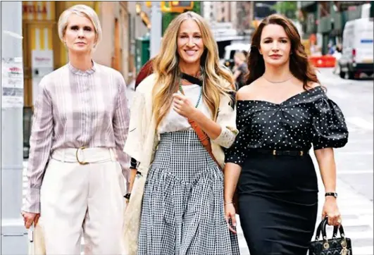  ??  ?? BACK IN ACTION: Cynthia Nixon, Sarah Jessica Parker and Kristin Davis in New York. Top left: Kim Cattrall cheers England with partner Russell Thomas