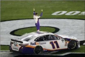  ?? CHRIS O’MEARA — THE ASSOCIATED PRESS ?? Denny Hamlin celebrates on the grass after winning a NASCAR Daytona 500 auto race Sunday at Daytona Internatio­nal Speedway in Daytona Beach, Fla.