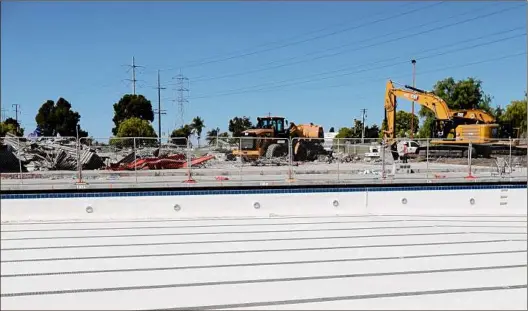  ?? Gregory Bull / Associated Press ?? Demolition work continues at Loma Verde Recreation Center Friday in Chula Vista, Calif. Why is the $24 million project that will rebuild the facility from the ground up, complete with a new pool, moving ahead while projects in other cities aren't? One reason involves the American Rescue Plan — the sweeping COVID-19 relief law that gives some government­s more flexibilit­y than others to spend their share of the money as they want.