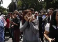  ?? REBECCA BLACKWELL — THE ASSOCIATED PRESS ?? A woman speaks on her cell phone as people evacuated from office building gather in Reforma Avenue after an earthquake in Mexico City, Tuesday.