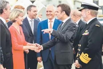  ?? — AFP photo ?? Macron (second right) shakes hand with Australian Minister for Foreign Affairs Julie Bishop as Turnbull looks on at Garden Island in Sydney.