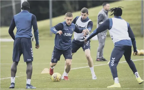  ??  ?? 0 Greg Docherty, left, and Jon Flanagan take part in a Rangers training session at the Hummel Training Centre yesterday.