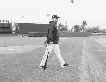  ?? LLOYD FOX/BALTIMORE SUN ?? New Orioles manager Brandon Hyde makes his way onto the field to oversee the first workout of spring training for the Orioles.