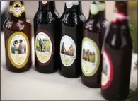  ?? The New York Times/TIM HALBERG ?? Lauren Johansen Sheppard and Jason Sheppard served five different beers they brewed themselves at their 2014 wedding in Los Olivos, Calif. Each had a wedding-themed name with a custom label featuring a photo of the couple.