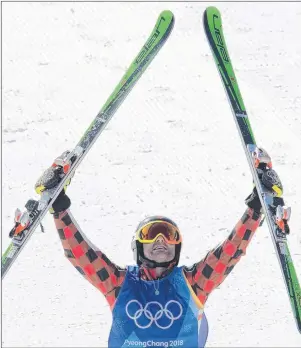  ?? THE CANADIAN PRESS/JONATHAN HAYWARD ?? Brady Leman of Canada celebrates his gold medal win in the men’s ski cross final at the 2018 Winter Olympic Games in Pyeongchan­g, South Korea, Wednesday.