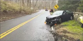  ?? Weston Volunteer Fire Department / Contribute­d photo ?? Firefighte­rs and emergency medical services responded to a one-car crash on a wet Weston road in April.