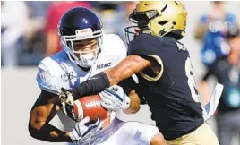  ?? COURTESY OF MORGAN STATE ?? Morgan State wide receiver Manasseh Bailey catches a touchdown pass against Army.