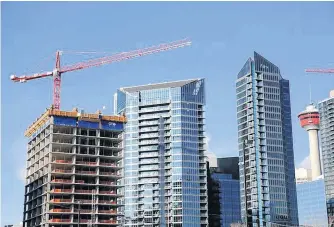  ?? REUTERS ?? Workers guide constructi­on equipment at a condominiu­m developmen­t in Calgary, on December 6, 2019.