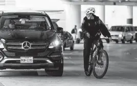  ?? ?? Officer Monica Duck directs people waiting to pick up a passenger to move their idling vehicle to the cellphone waiting lot.