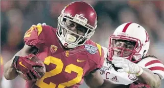  ?? Robert Gauthier Los Angeles Times ?? USC TAILBACK Justin Davis breaks free of Nebraska safety Corey Cooper during the Holiday Bowl in December. Davis rushed for 595 yards last season.