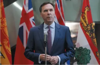  ?? CP FILE PHOTO ?? Finance Minister Bill Morneau speaks with reporters before a meeting with provincial and territoria­l finance ministers in Ottawa on June 26.