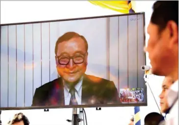  ?? MENEA HONG ?? Former CNRP president Sam Rainsy, seen here speaking via Skype feed yesterday at a memorial for victims of a 1997 grenade attack on an opposition rally, was convicted on the same day by the Phnom Penh Municipal Court of defamation and incitement for suggesting the government killed political analyst Kem Ley.