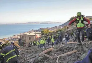  ?? SALVATORE LAPORTA/AP ?? Rescuers work Monday after heavy rainfall triggered a landslide that collapsed buildings on the Italian island of Ischia.