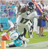  ?? LYNNE SLADKY/ASSOCIATED PRESS ?? Ravens wide receiver Jordan Lasley dives to the 2-yard line Saturday against the Dolphins in Miami Gardens, Fla.