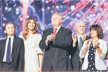  ??  ?? Donald Trump (centre) with (from left) his son Barron Trump, wife Melania Trump, vice presidenti­al candidate Mike Pence and Karen Pence acknowledg­e the crowd at the end of the the Republican National Convention. — AFP photo