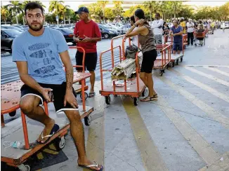  ?? MARTA LAVANDIER / AP ?? Max Garcia of Miami waited in a line since dawn to purchase plywood sheets at The Home Depot store Wednesday in North Miami, Fla. Florida residents are preparing for the possible landfall of Hurricane Irma, the most powerful Atlantic Ocean hurricane in...