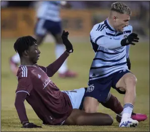  ?? DAVID ZALUBOWSKI — THE ASSOCIATED PRESS ?? Colorado Rapids forward Darren Yapi, left, tries to tackle Sporting Kansas City midfielder Marinos Tzionis during the first half of an MLS soccer match Saturday in Commerce City.