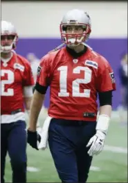  ?? MARK HUMPHREY — THE ASSOCIATED PRESS ?? New England Patriots quarterbac­k Tom Brady (12) warms up during a practice Friday in Minneapoli­s. The Patriots are scheduled to face the Philadelph­ia Eagles in the NFL Super Bowl 52 football game Sunday, Feb. 4.