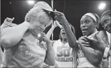  ?? JANET BLACKMON MORGAN/THE SUN NEWS/AP PHOTO ?? North Carolina coach Sylvia Hatchell is greeted by her players after their 79-63 win over Grambling State on Tuesday at Myrtle Beach. S.C.