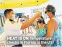  ??  ?? HEAT IS ON Temperatur­e checks in Florida in the US