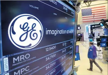  ?? Richard Drew Associated Press ?? GENERAL ELECTRIC is cutting costs and selling assets after posting last year’s biggest drop on the Dow Jones industrial average. Its shares fell 2.9% to $18.21 on Tuesday after being down as much as 4.1%.