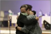  ?? JAE C. HONG — THE ASSOCIATED PRESS ?? Jason Aguilar, left, a senior pastor at Arise Church, comforts Billy Chang, a 67-year-old Taiwanese pastor who survived Sunday’s shooting at Geneva Presbyteri­an Church, during a prayer vigil in Irvine Monday.