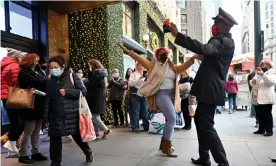  ?? Photograph: Alexi Rosenfeld/Getty Images ?? Black Friday in New York. Many shoppers chose to pick up merchandis­e curbside rather than venturing inside stores.