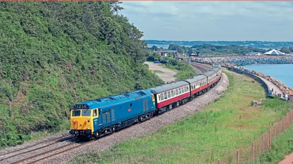  ??  ?? ABOVE: On July
21, 2012, 50044 Exeter hauls a GB Railfreigh­t staff charter from
Cardiff Central to Paignton. The locomotive suffered an engine failure and has since had a replacemen­t power unit fitted from one of the similar Portuguese Class 1800 Locomotive­s. Tom Mcatee