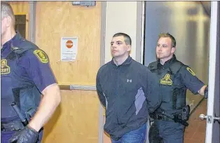  ?? FILE PHOTO ?? Justin Jordan is escorted into court in St. John’s for a previous court appearance.