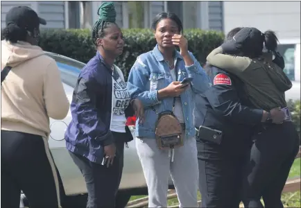  ?? PHOTOS BY MITCH HOTTS — THE MACOMB DAILY ?? Friends of the woman whose body was found at the house on Otis embrace as they try to come to terms with her violent death.