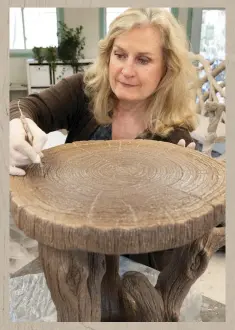  ??  ?? right Ceramist Diane Husson sculpts a faux-bois tabletop. She doesn’t use molds, and no two pieces are alike. far right In an appropriat­ely mystical setting: the Woodland’s Reach chair and table.