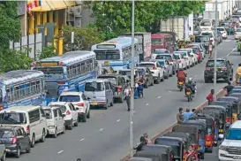  ?? (AFP) ?? Motorists queue to buy fuel at Ceylon petroleum corporatio­n fuel station in Colombo on Wednesday