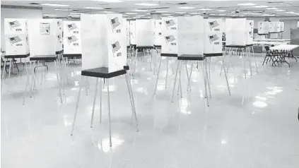  ?? JORGE NUNEZ/PALM BEACH COUNTY ?? Privacy screens are stacked on top of one another and attached with fasteners at an early voting site for the August 2020 primary.