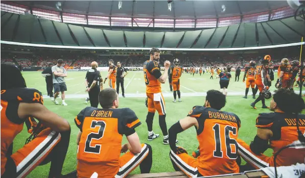 ?? — THE CANADIAN PRESS FILES ?? QB Mike Reilly, centre, and his Lions teammates could be back in action at B.C. Place this fall if team owner Rick LeLacheur gets his way. Stadium officials are considerin­g ideas such as seating fans in both the bottom and top decks to allow for social distancing.