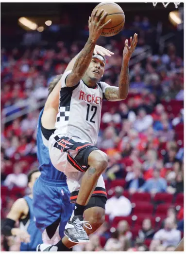  ??  ?? Houston Rockets guard Lou Williams goes up for a basket in front of Minnesota Timberwolv­es forward Nemanja Bjelica during the second half of an NBA basketball game Saturday in Houston. (AP)