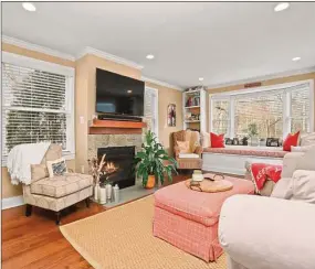  ?? Contribute­d by Anderson Associates ?? The home’s living room has a new gas fireplace and a charming built-in window seat.