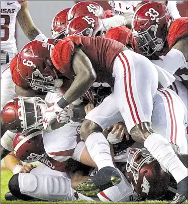  ?? Arkansas Democrat-Gazette/BENJAMIN KRAIN ?? A swarm of Alabama defenders brings down Arkansas quarterbac­k Cole Kelley during the second quarter of the Razorbacks’ game Saturday night in Tuscaloosa, Ala. Kelley, a redshirt freshman, completed 23 of 42 passes for 200 yards with 1 touchdown and 1...