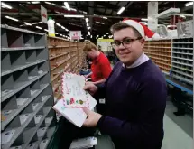  ??  ?? Huge sacks of mail pass through the depot, so our reporter Niall Christie puts on a Santa hat and lends a hand