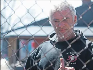  ?? BRIAN MCINNIS/THE GUARDIAN ?? A member of the Charlottet­own Harley Club shows his displeasur­e at the news photograph­er as police executed search warrants on the clubhouse Saturday morning. A woman, whose property borders the club, said she has no issue with the club or its members....