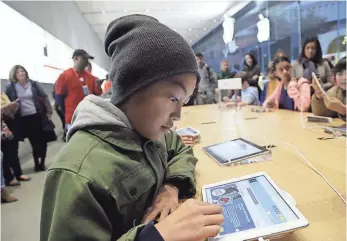  ?? MARCIO JOSE SANCHEZ, AP ?? Tyson Navarro, 10, of Fremont, Calif., learns to build code using an iPad at an Apple store workshop in 2013. Apple stores were participat­ing in computer science education week.