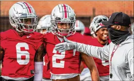  ?? AP ?? Ohio State receiver Chris Olave (2) surprised many with his decision to put the NFL on hold, but he says he wants to improve his game while helping the Buckeyes win a title.