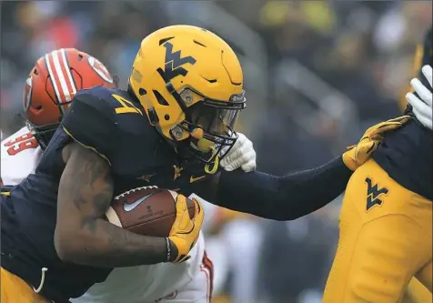  ?? Ronald Martinez/Getty Images ?? West Virginia running back Kennedy McKoy tries to follow his blockers for a short gain the Heart of Dallas Bowl Tuesday at the Cotton Bowl.
